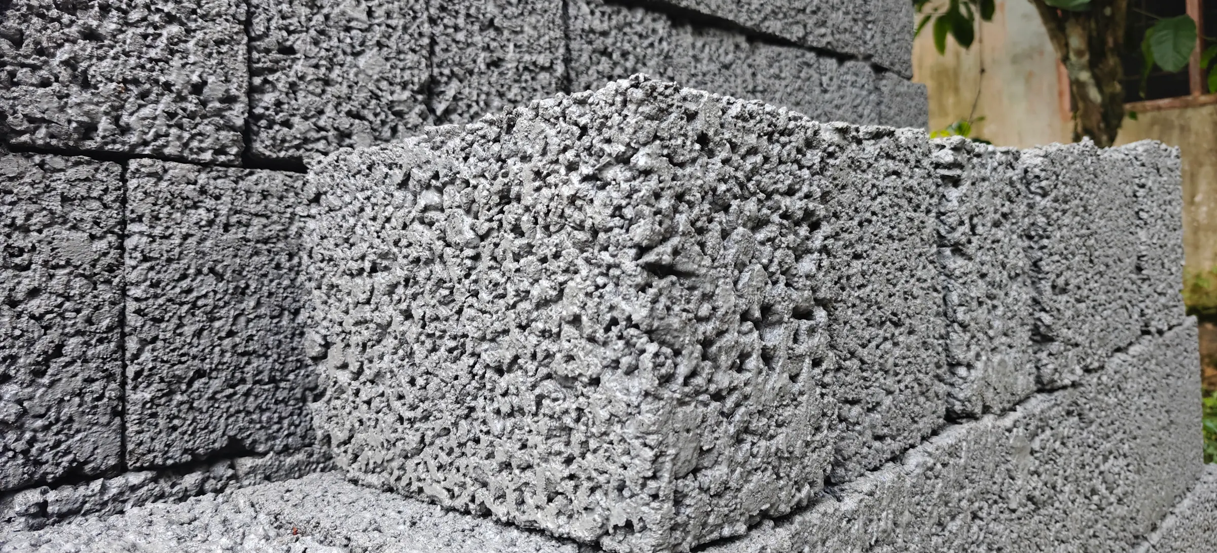 Finished cement blocks in a cured course, cast from blue metal, rock sand, cement and water