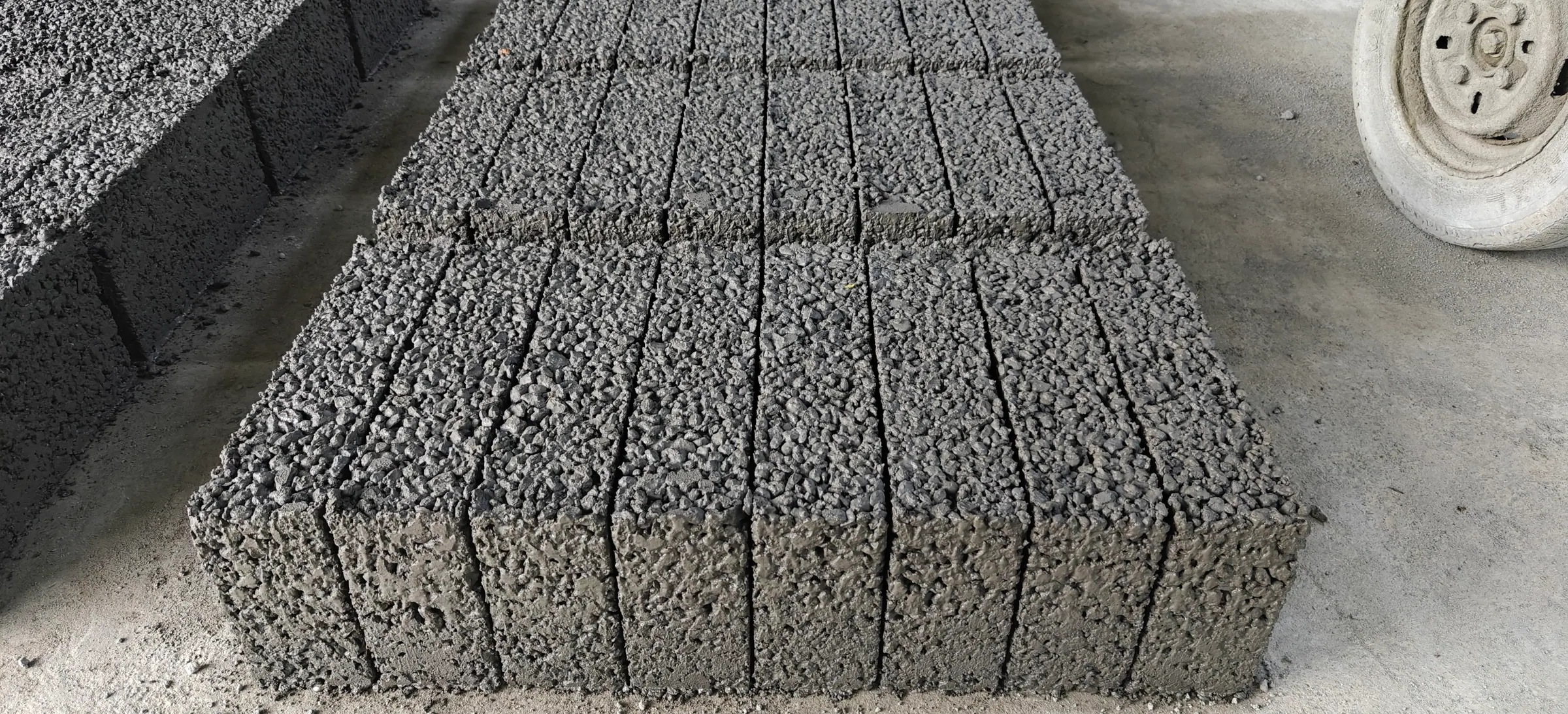 Cement blocks curing in rows under cover